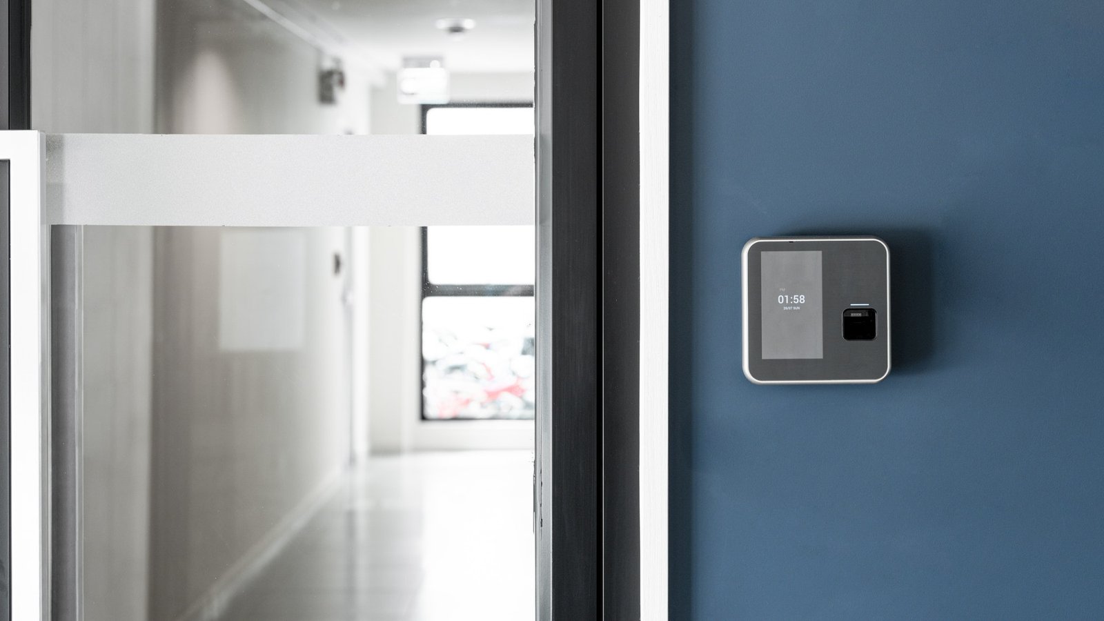finger-or-card-scanner-device-placed-on-blue-wall-to-unlock-the-entrance-door.jpg